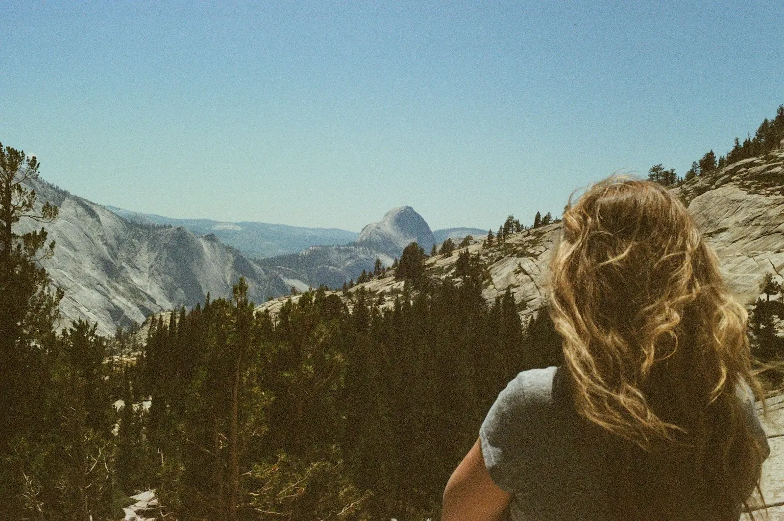 Woman looking at a vast mountain landscape